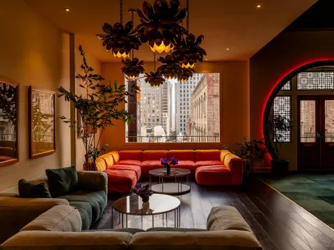 The lounge at Mister Jiu's in San Francisco's Chinatown, with a red neon-lit moon gate entrance