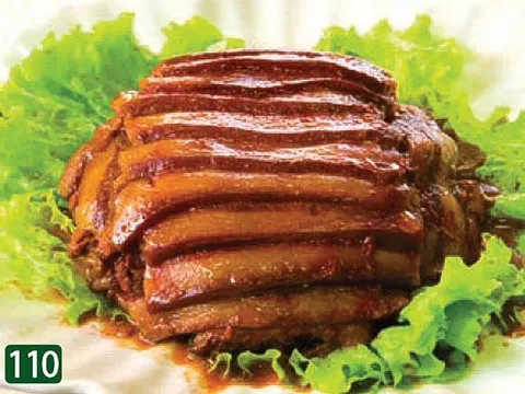 Braised sliced pork belly glazed in dark sauce, fanned over green lettuce, a Cantonese dish served at Star Kitchen in Denver